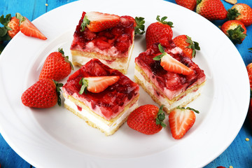 strawberry cake with fresh strawberries and whipped cream.