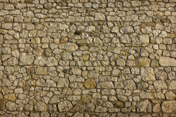 .background texture of an ancient masonry of uneven gray stones closeup