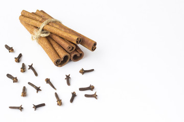 Cinnamon sticks and a spicy clove on a white background. Top view