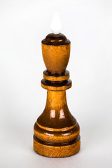 The macro shot of the black chess king of wood on the white background. The chess piece is isolated on white and a clipping path is provided for easy extraction.