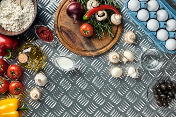Cooking Pizza. Pizza ingredients on the iron table with copy space, top view.