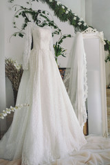 wedding dress weighs in the bride's room near the mirror