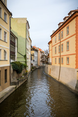 Fototapeta na wymiar Old colorful buildings and water canal on the Kampa Island in Prague, Czech Republic.
