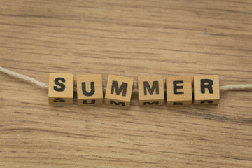 Fototapeta premium inscription / summer / arranged from blocks strung on a string