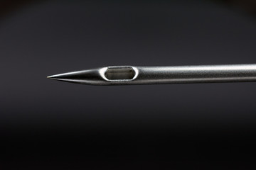 syringe needle on dark background concept of addiction selective focus