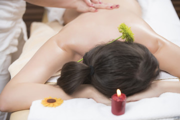 Fototapeta na wymiar Beautiful young woman relaxing massage at beauty spa