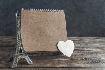 notebook with heart on wooden background