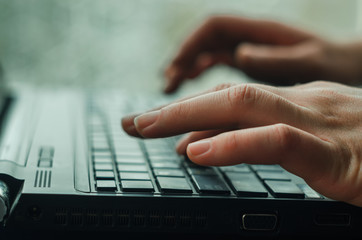 Close-up of typing female hands on keyboard