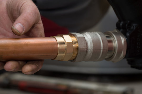 workers cut a copper pipe