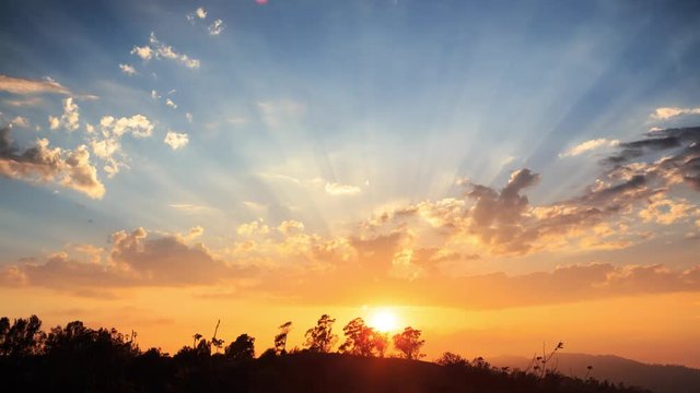Beautiful scenic sunset with rays of sun shining through clouds 4K UHD Timelapse