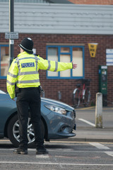 policeman directing and managing traffic on busy road 