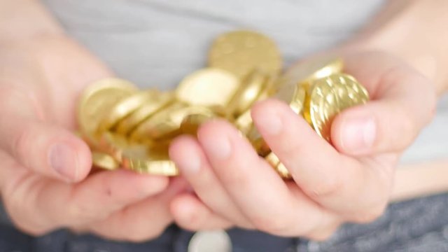 golden coins in hands