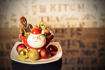 Ginger bread cookies inside a santa claus porcelain pot.