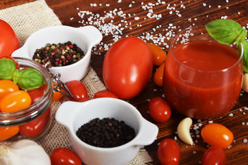 spicy fresh tomato juice with colored pepper and basil