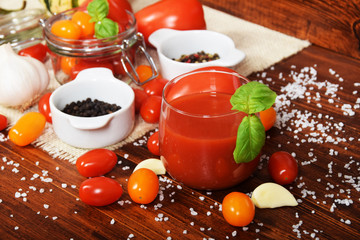 spicy fresh tomato juice with colored pepper and basil with free space for text