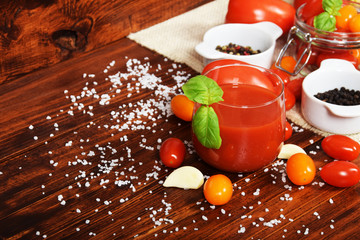 spicy fresh tomato juice with colored pepper and basil with free space for text