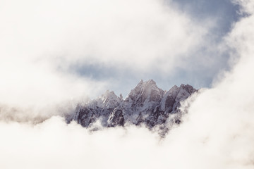 Beautiful peaks in the magical clouds with sunshine on a foggy morning, Alps mountains in Austria, Europe