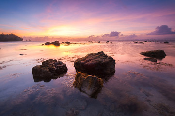Beautiful seascape scenery during sunrise at beach in Malaysia.Soft focus due to long exposure.