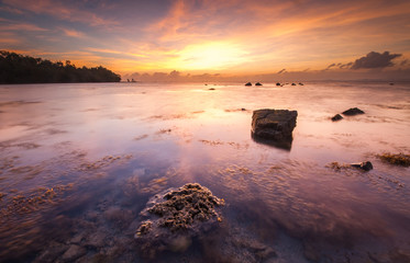 Beautiful seascape scenery during sunrise at beach in Malaysia.Soft focus due to long exposure.