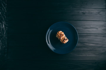 curd cake in a plate lies on a wooden background