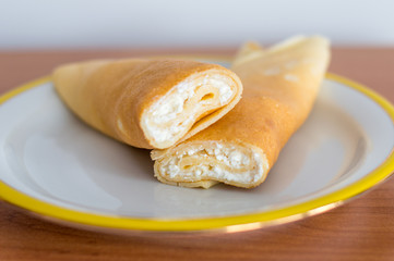 Home-made Polish pancake called nalesniki filled with sweet white cheese.