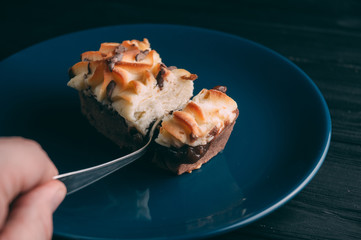 curd cake in a plate lies on a wooden background