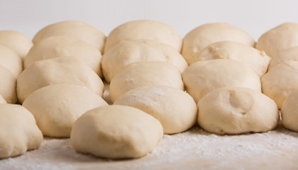 Fototapeta na wymiar Pieces of dough prepared for pies making