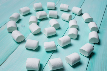 marshmallow on azure blackboard lined up in the form of a spiral, concept