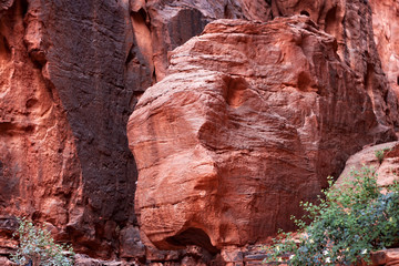 Red stone walls of the canyon of Wadi Rum desert in Jordan. Wadi Rum also known as The Valley of the Moon is a valley cut into the sandstone and granite rock in southern Jordan to the east of Aqaba.