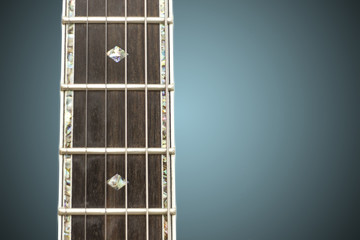 Close up macro of guitar strings and fret board