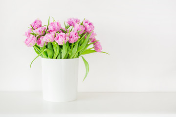 Fresh bright bouquet of pink tulip in white bucket. Beautiful greeting card. Spring holidas concept. Copyspace. Place for your text
