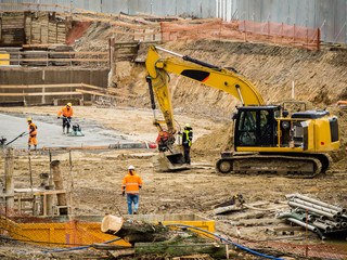 Tunnel construction site during work in the depression with the use of excavator and manual machines