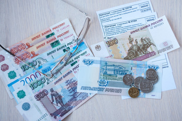 Russian money, glasses and receipts for pension are on the table