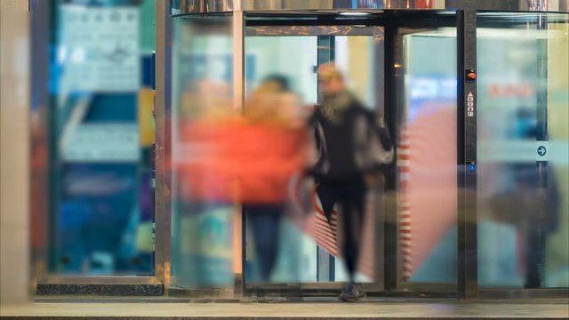 Shopping center entrance with blurred crowd of  people. Time lapse