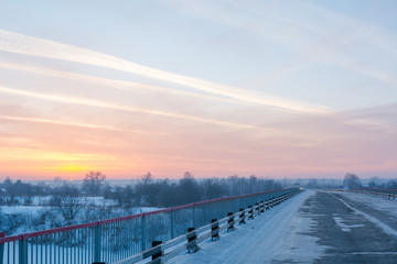 Road at sunset in winter. Snowy road at sunset.