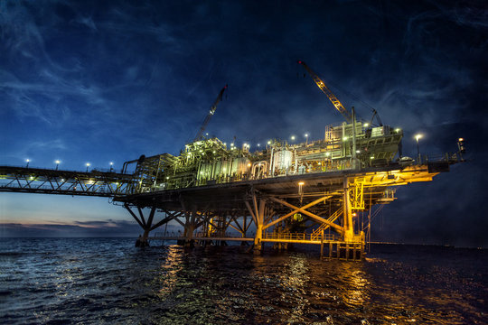 oil rig at sunset with vibrant colors