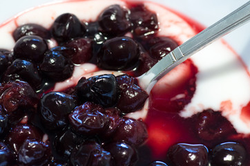 Closeup of cherries mixed with yogurt