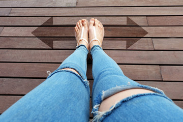 Selfie Shoes with Two Directions Arrows Choice. Woman Shoes with Drawn Arrows on Wooden Floor Background Great for Any Use.