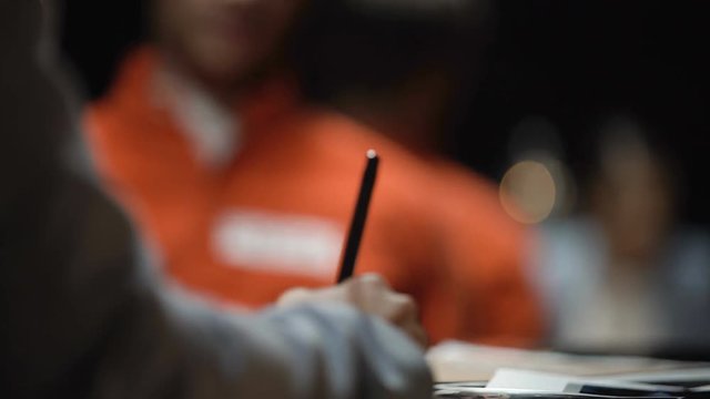 Advocate woman making notes of prisoner statements in robber case file, record