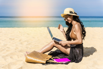 woman happy relax in vacation using laptop computer on the beach. Freelance work concep