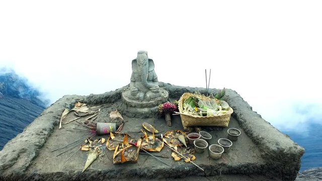 Altar with Ganesha (hindu God) on top of the bromo volcano crater on Java Indonesia