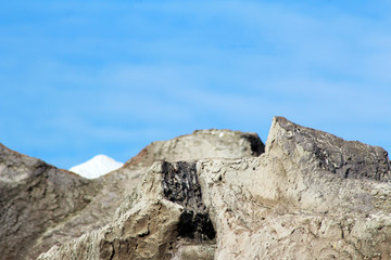 A rock wall against a blue sky.