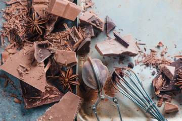 Header with chocolate pieces, spices, anise stars, cinnamon and cocoa on a stone background. Cooking desserts and home concept.