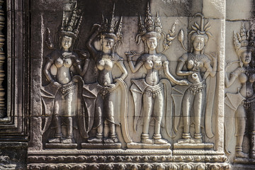 Fototapeta na wymiar Siem Reap Angkor Wat apsara dancer ancient stone carving on wall and pillar
