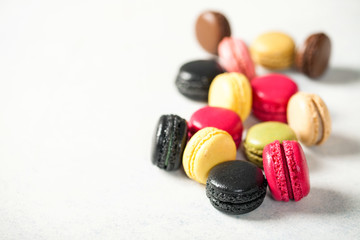 Different macaroons on a light background. Selective focus. Copy space