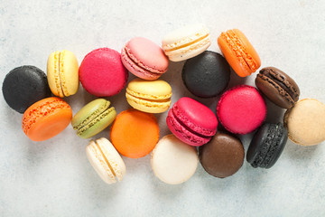Different macaroons on a light background. Top view
