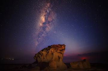 milkyway galaxy rise above lone tree at Kudat, Sabah Malaysia. Image contain soft focus, blur and...