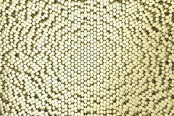 Pattern of brushed gold metal cylinders of different length