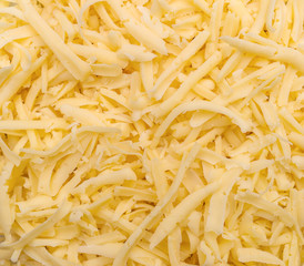 Grated cheese as food background. Top view.