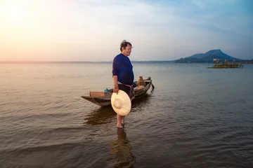 Foto op Canvas Asian fisherman throwing fishing net in lake at sunrise time.(Lifestyle of the population living in the river) © Thasist